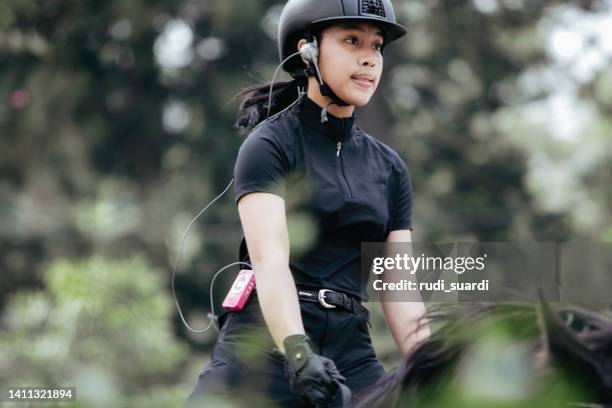 dressage, woman with her horse galloping - vospaard stockfoto's en -beelden