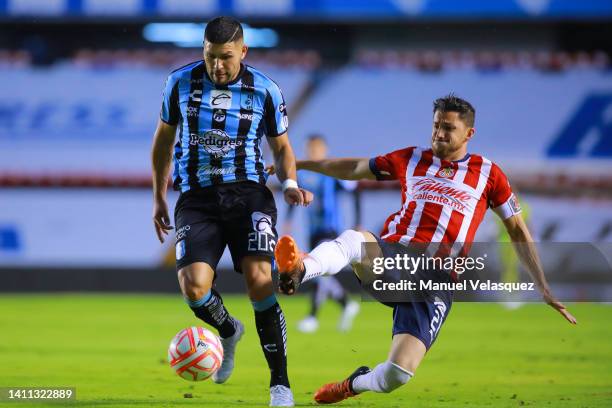 David Barbona of Queretaro fights for the ball with Hiram Mier of Chivas during the 5th round match between Queretaro and Chivas as part of the...