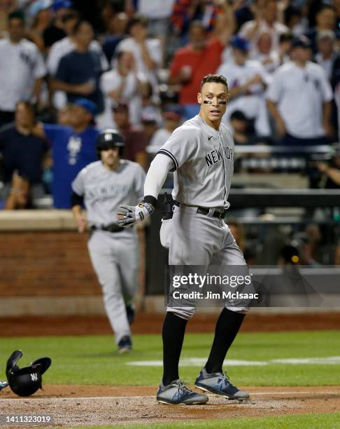 Aaron Judge of the New York Yankees drops his helmet after striking out to end the seventh inning against the New York Mets with two men on base at...