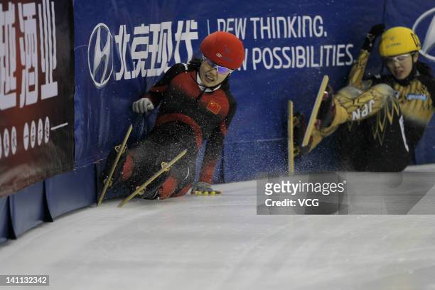 Ayuko Ito of Japan and Li Jianrou of China fall in the Women's 500m Preliminaries during day two of the ISU World Short Track Speed Skating...