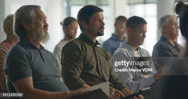 group of business men sitting in an office conference room, developing skills and taking notes. closeup of professional business people in seats attending a seminar or workshop to learn in an office - presentation meeting room stock pictures, royalty-free photos & images