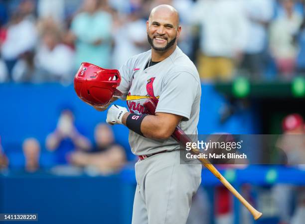 Albert Pujols of the St. Louis Cardinals salutes the crowd in a break against the Toronto Blue Jays in the first inning during their MLB game at the...