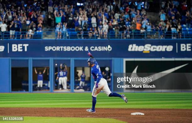 George Springer of the Toronto Blue Jays rounds the bases on his grand slam home run against the St. Louis Cardinals in the sixth inning during their...