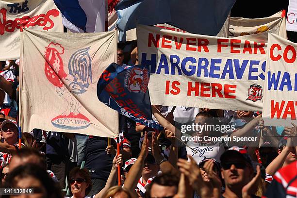 Roosters fans hold up banners during the round two NRL match between the Sydney Roosters and the Penrith Panthers at Allianz Stadium on March 11,...