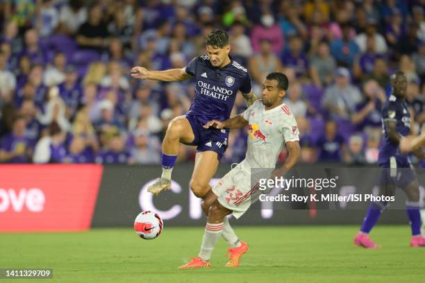 Alexandre Pato of Orlando City SC battles for the ball with Cristian Casseres Jr. #23 of the New York Red Bulls during U.S. Open Cup semifinal game...
