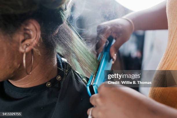 close up of black hairdresser straightening client's hair - afro hairstyle bildbanksfoton och bilder