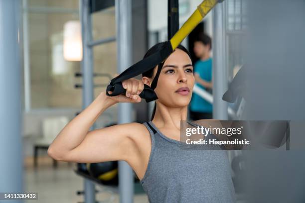 fit woman training at the gym using trx straps - suspension training stock pictures, royalty-free photos & images