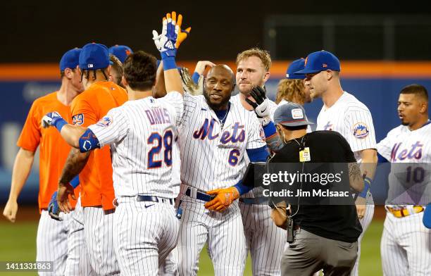 Starling Marte of the New York Mets celebrates his ninth inning game winning base hit against the New York Yankees with his teammates at Citi Field...