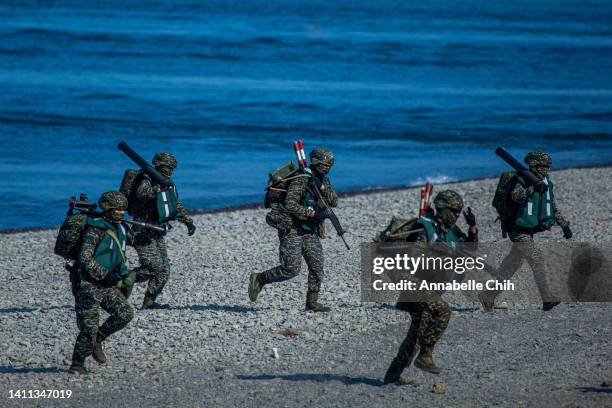 Soldiers disembark from AAV7 amphibious assault vehicles during the Han Kuang military exercise, which simulates China's People's Liberation Army...