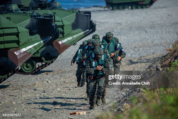 Soldiers disembark from AAV7 amphibious assault vehicles during the Han Kuang military exercise, which simulates China's People's Liberation Army...