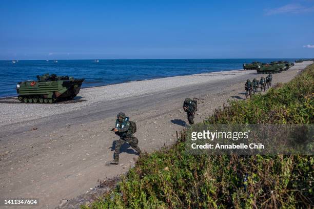 Soldiers disembark from AAV7 amphibious assault vehicles during the Han Kuang military exercise, which simulates China's People's Liberation Army...