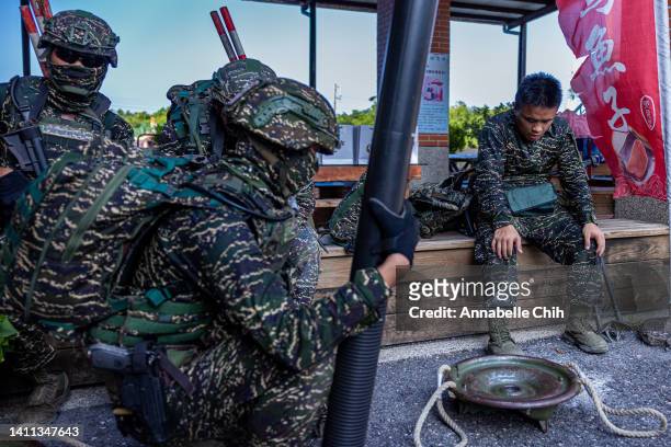 Soldiers recuperate after an amphibious landing drill during the Han Kuang military exercise, which simulates China's People's Liberation Army...