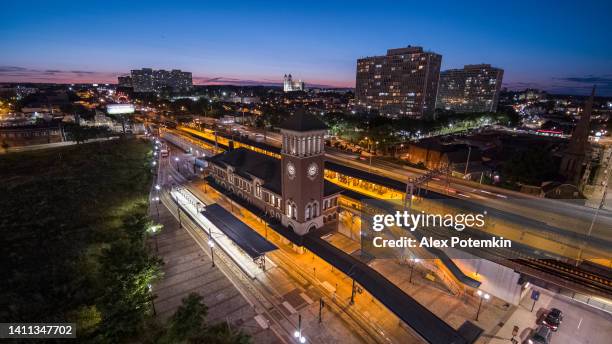 broad street light rail station and city view of newark, new jersey illuminted at sunset. - new jersey landscape stock pictures, royalty-free photos & images