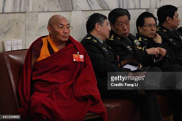 Tibetan delegate and Chinese military delegates arrive at The Great Hall Of The People before the fourth plenary meeting of the National People's...