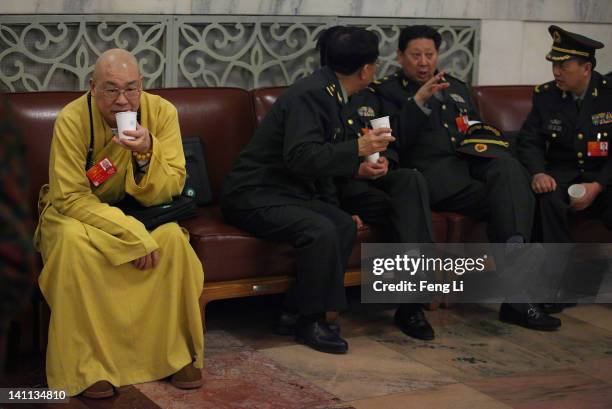 Delegate of Buddhist monk and Chinese military delegates arrive at The Great Hall Of The People before the fourth plenary meeting of the National...