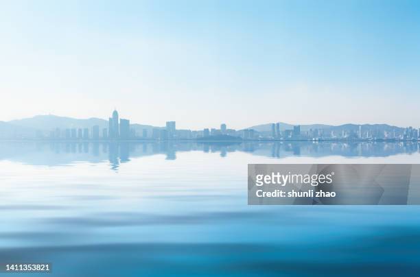 the city reflected on the sea - clear sky stock pictures, royalty-free photos & images