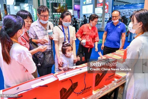 People visit Vietnam chocolate booth during the 2nd China International Consumer Products Expo at the Hainan International Convention and Exhibition...