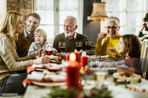 glückliche großfamilie im gespräch während des neujahrsessens zu hause. - 40 year old female stock-fotos und bilder