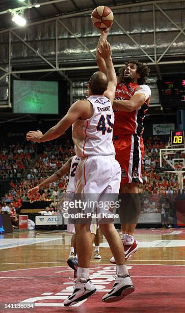 Matt Knight of the Wildcats shoots over Dusty Rychart of the Taipans during the round 23 NBL match between the Perth Wildcats and the Cairns Taipans...