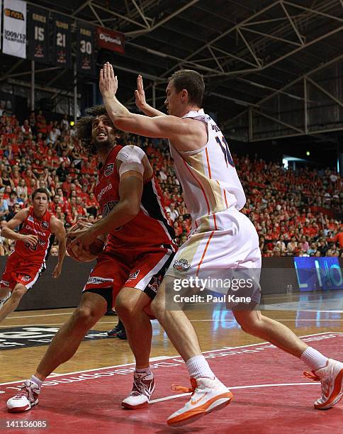 Matt Knight of the Wildcats drives to the basket against Jeff Dowdell of the Taipans during the round 23 NBL match between the Perth Wildcats and the...