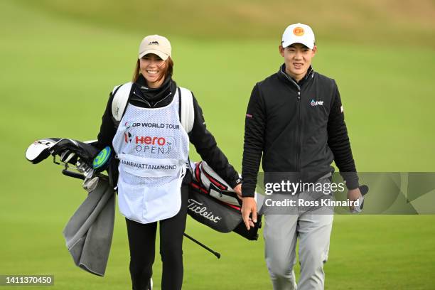 Atiwit Janewattananond of Thailand and their Caddy walk down freeway 12 during Day One of the Hero Open at Fairmont St Andrews on July 28, 2022 in St...