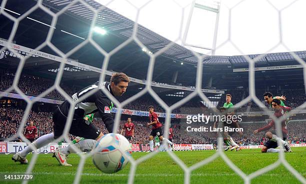 Claudio Pizarro of Bremen scores his teams first goal against goalkeeper Ron Robert Zieler of Hannover during the Bundesliga match between SV Werder...