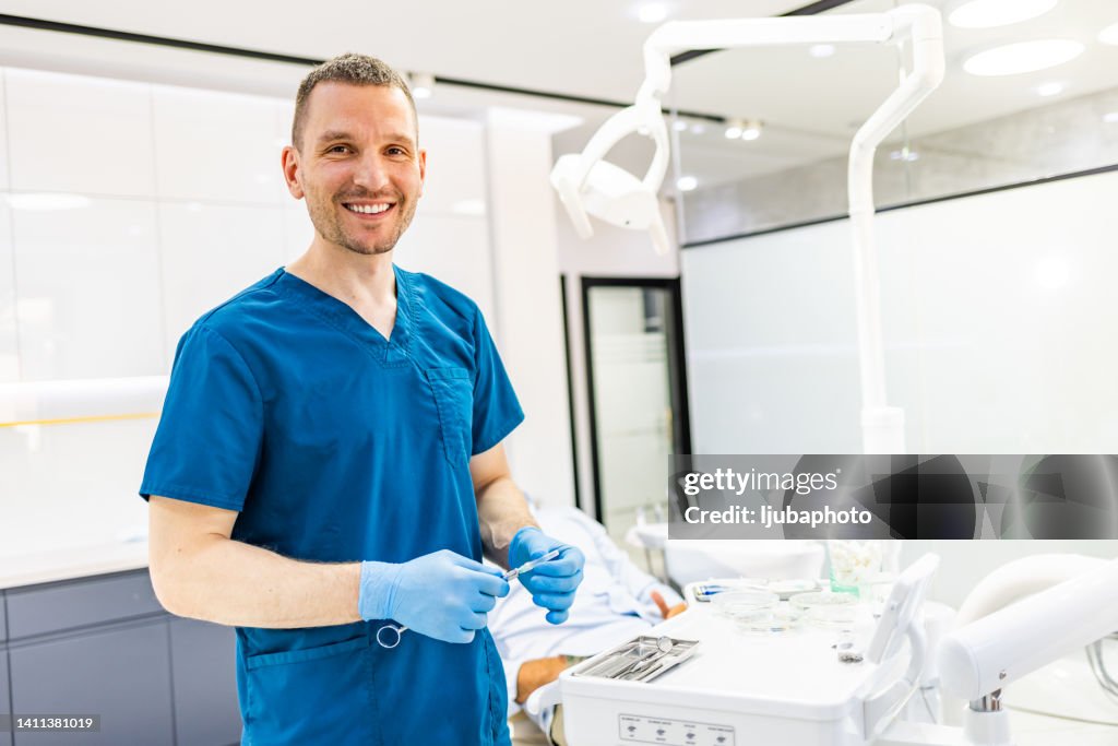 Portrait of dentist with anesthetic injection syringe