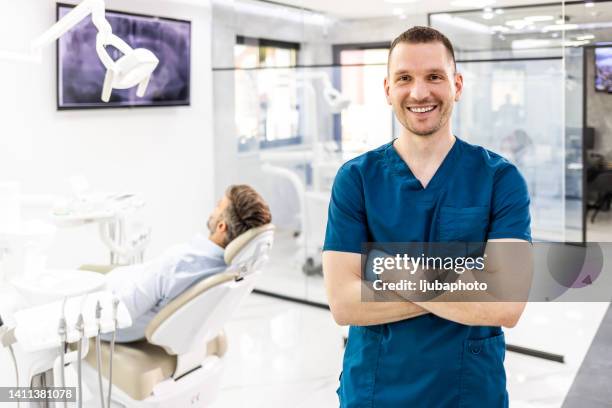 portrait of young male nurse in hospital - male dentist stock pictures, royalty-free photos & images