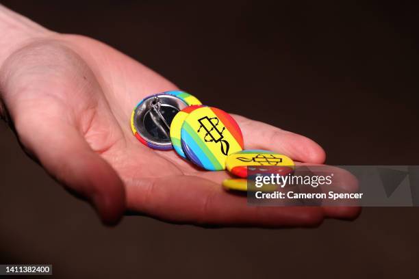 Rainbow badges are handed to fans on arrival during the round 20 NRL match between the Manly Sea Eagles and the Sydney Roosters at 4 Pines Park on...