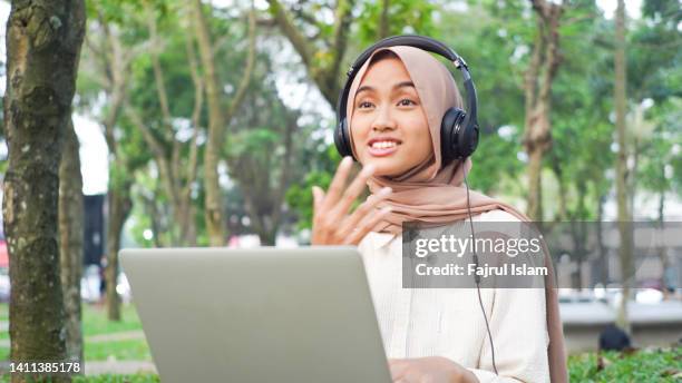 disability hijab women make a video conference with laptop - far islam stock pictures, royalty-free photos & images