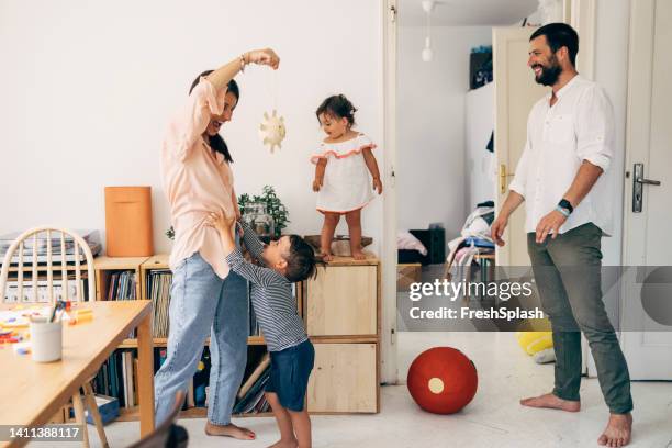 parents playing with their children - family chaos stock pictures, royalty-free photos & images