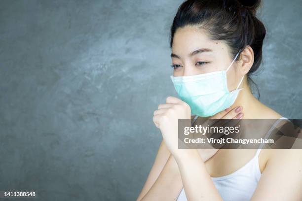 female wearing medical mask, cough, sic, ill - arenavirus stock pictures, royalty-free photos & images