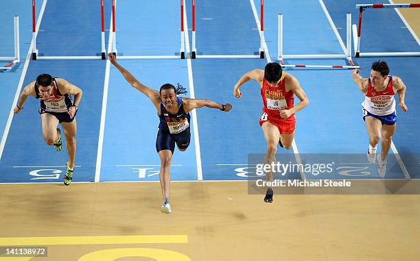 Aries Merritt of the United States crosses the line to win gold ahead of silver medalist Lui Xiang of China , Andrew Pozzi of Great Britain and...