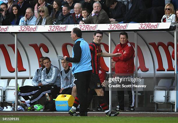 Gareth Barry of Manchester City is angry about being substitued and has words with assistant manager David Platt during the Barclays Premier League...