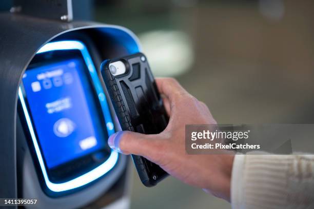 close up young man using smart phone scanning transport ticket - access control stock pictures, royalty-free photos & images