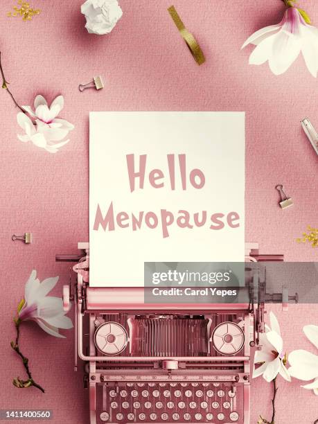 menopause concept .typewritter with the word menopause written.pink background - progesterone fotografías e imágenes de stock