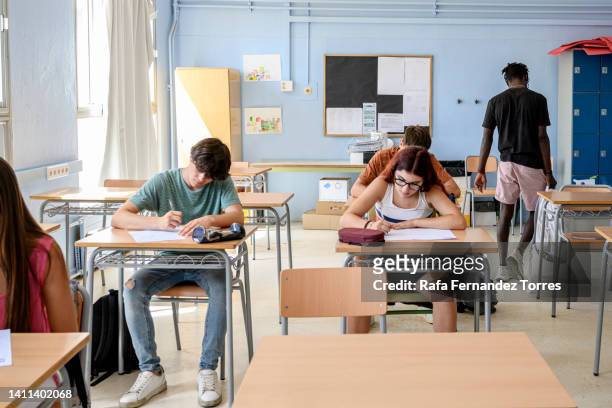 black teenager leaving classroom after exam test - arriving late class ストックフォトと画像