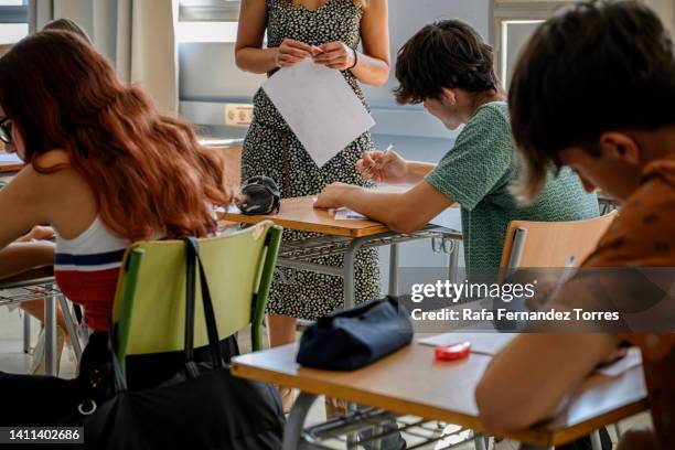 high school students writing a test in the classroom. - gymnasieexamen bildbanksfoton och bilder