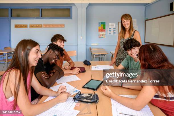 college students working in group with technology - learning spanish stock pictures, royalty-free photos & images