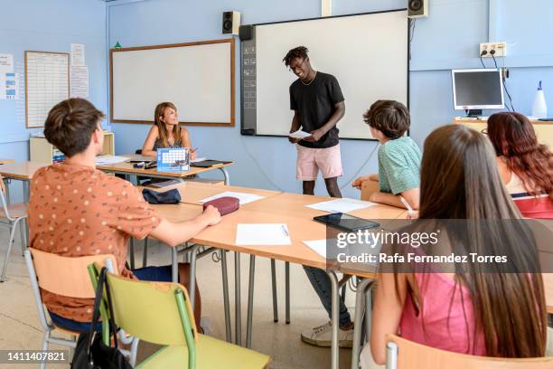 black teen student giving presentation in front of class - boy giving speech stock pictures, royalty-free photos & images