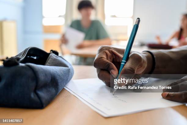 close up of unrecognizable student taking notes on a class. - testing in barcelona stockfoto's en -beelden
