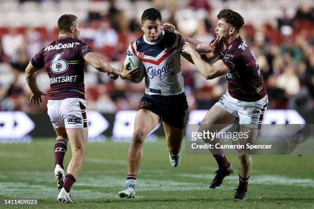 Joseph Manu of the Roosters is tackled during the round 20 NRL match between the Manly Sea Eagles and the Sydney Roosters at 4 Pines Park on July 28...