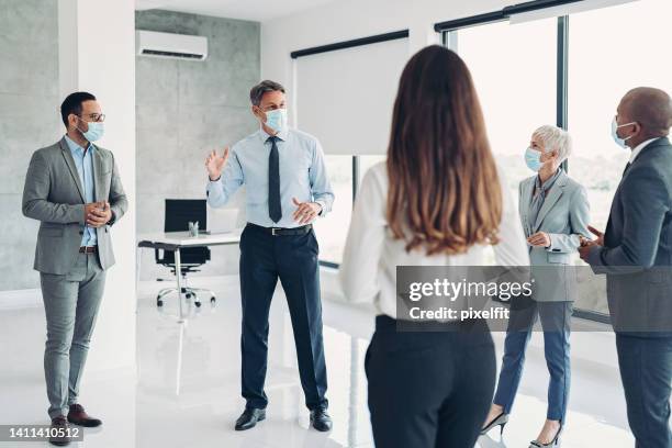 business meeting with safety measures - businesswoman mask stock pictures, royalty-free photos & images