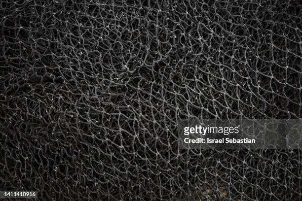 close-up of a used black fishing net - knooppatroon stockfoto's en -beelden