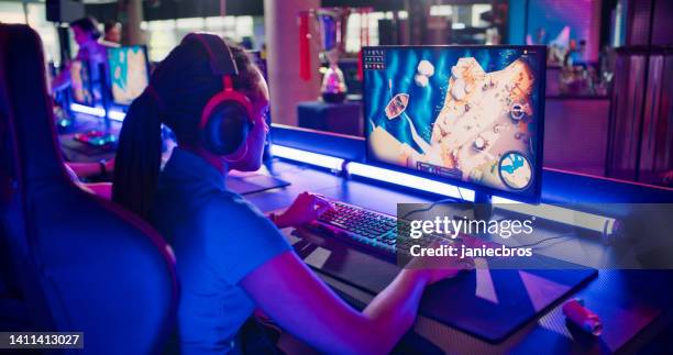 diverse blue pro gamer team with african ethnicity female leader competing in video game esport championship - stadium screen stock pictures, royalty-free photos & images