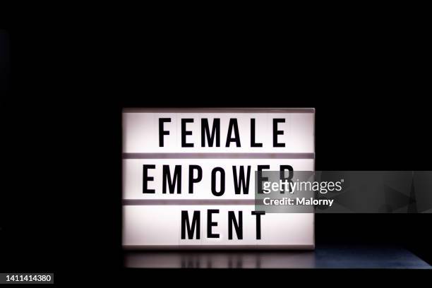 female empowerment. lightbox on black background. - lightbox stock-fotos und bilder