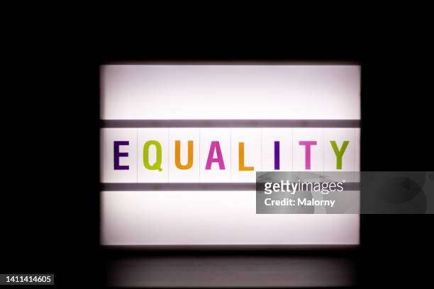 equality. lightbox on black background. - light box stock-fotos und bilder