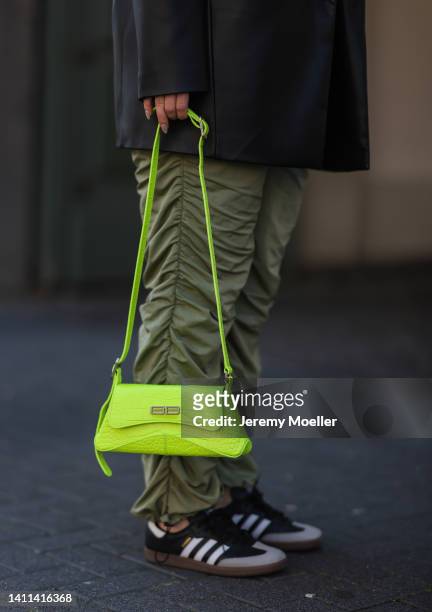 Maria Barteczko is seen wearing a Zara black vegan leather blazer, Asos black cropped top, Source Unknown green drawstring parachute pants, Adidas...