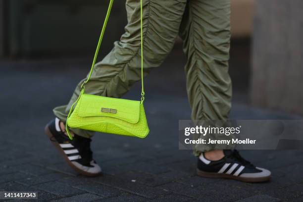 Maria Barteczko is seen wearing a Zara black vegan leather blazer, Asos black cropped top, Source Unknown green drawstring parachute pants, Adidas...