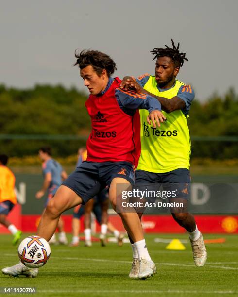 Facundo Pellistri and Fred of Manchester United in action during a first team training session at Carrington Training Ground on July 27, 2022 in...